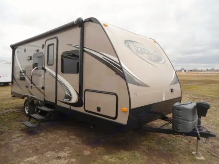 Tan Kodiak travel trailer parked outdoors, ready for your next rv rental adventure.. Dutchmen Kodiak 2014