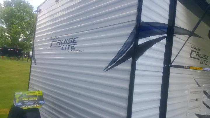 Side of a white Salem Cruise Lite RV with gray stripes & black awning, an excellent choice for rv rental.. Forest River Salem Cruise Lite 2017