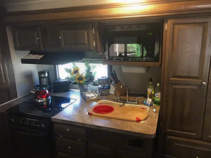 The galley are is built into the slide out. It includes a large counter area, 3 burner stove top and oven, microwave.double sink, toaster,coffee put (Kurig style), spices, tea pot, knife block, cutting boards, dishes and cook ware. . Forest River Flagstaff Micro Lite 2016