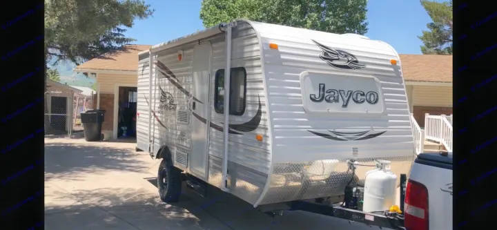 Jayco travel trailer RV rental parked on a sunny driveway, ready for your next outdoor adventure.. Jayco Jay Flight SLX 2015