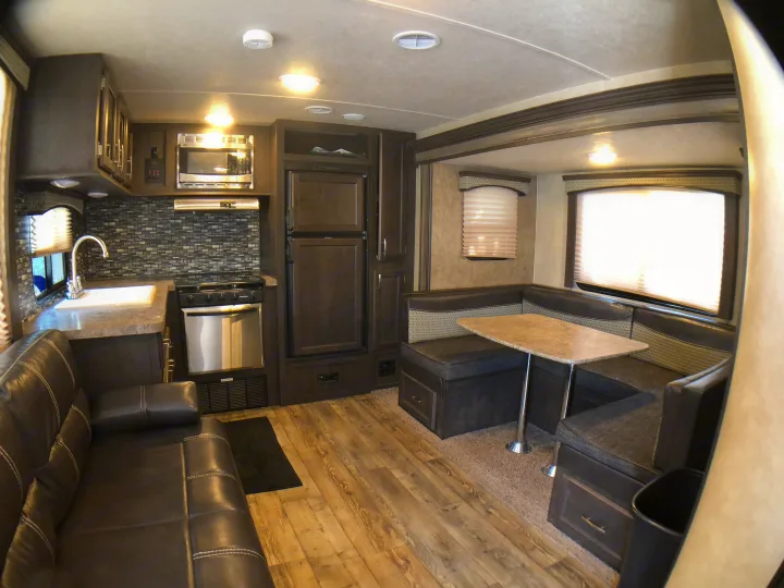 Spacious rv rental interior featuring a full kitchen, comfy sofa, and dinette. Perfect for your next adventure!. Forest River Evo 2017