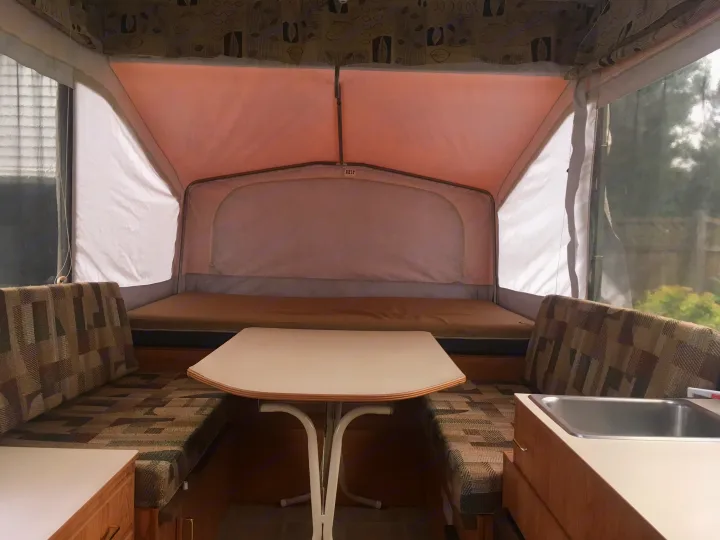 Queen bunk and dinette. (Table has since been replaced.) . Jayco Qwest 2003