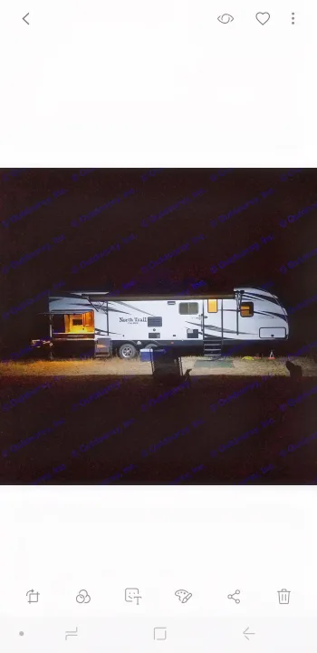 Cozy RV rental lit up at night, showcasing a peaceful campsite under the stars. Ideal for camping and travel.. Heartland Other 2016