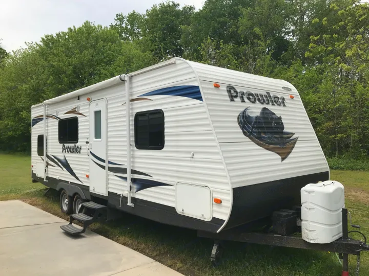 Clean exterior with functional awning, exterior storage compartments, and two larger propane tanks so you will never run out of propane. . Heartland Prowler 2012