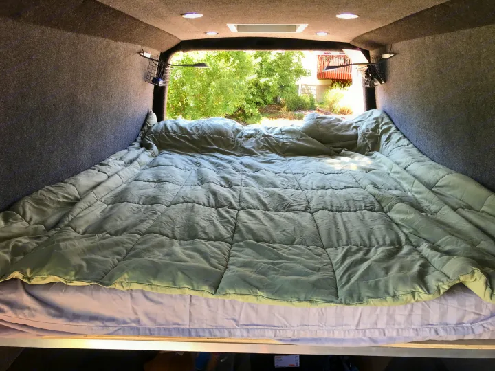California King Bed, on a 4" memory foam mattress.  Reading lights on each side. . Mercedes-Benz Sprinter 2015