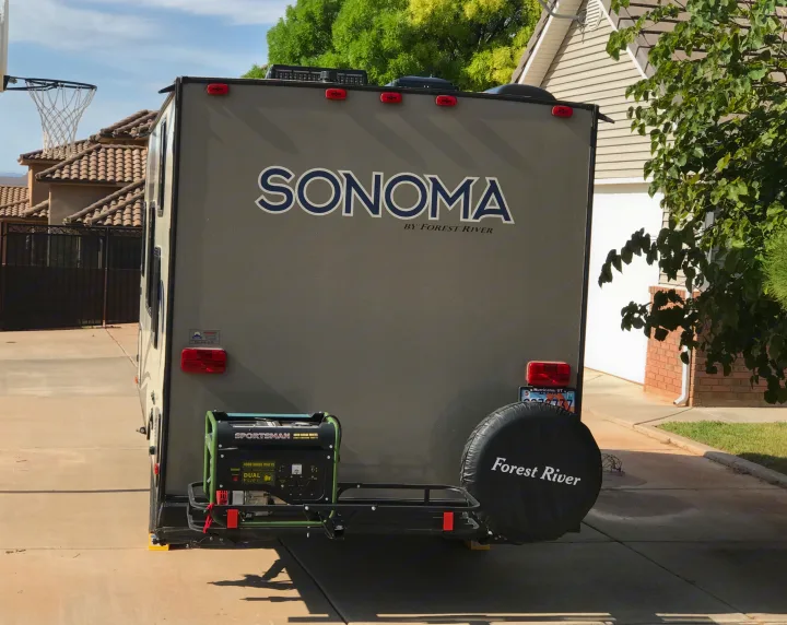 Rear view of an RV rental (Sonoma by Forest River) equipped with a Sportsman generator and spare tire.. Forest River Forester 2017