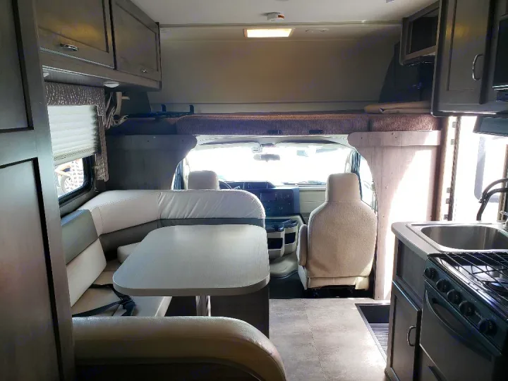Inside this modern RV rental, find a comfortable dinette, functional kitchen, and over-cab bunk. Ideal for family adventures.. Winnebago Minnie Winnie 2017