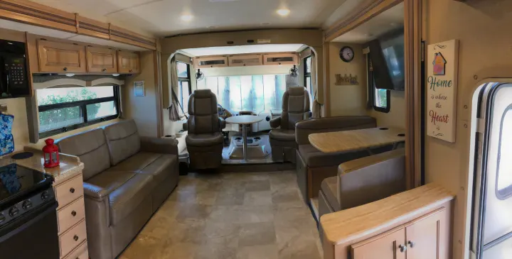 Spacious RV rental interior with kitchen, living, and dining areas. This well-appointed space offers comfortable travel.. Thor Windsport 2018