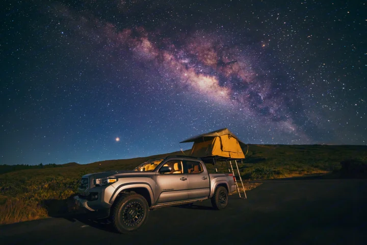 Stargaze from your RV rental! A Tacoma truck with rooftop tent under the vibrant Milky Way, ideal for remote camping.. toyota tacoma 2023
