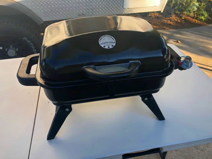 This black portable gas grill on a white table is perfect for outdoor cooking during your rv rental camping trips.. Jayco Jay Flight SLX 2015