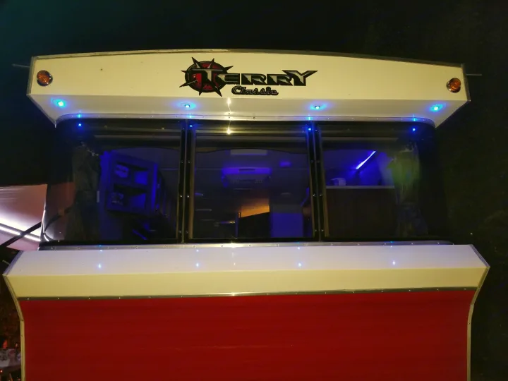 Night shot of an RV rental with blue interior and exterior lights. Features red and white exterior, Gerry Classic logo.. Other Other 2019