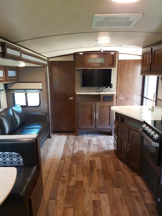 Explore the comfortable interior of our RV rental, complete with kitchen, living area, and a flat-screen TV.. Cruiser Rv Corp Radiance 2019