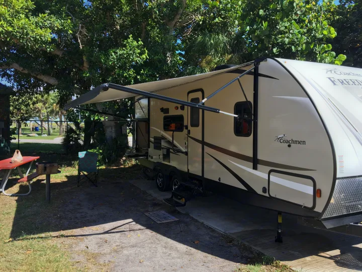 Extended awning helps keep it cool at the beach when it's time to grill!. Coachmen Freedom Express 2017