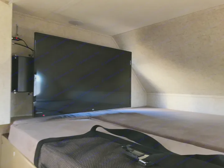 RV rental interior: A flat-screen TV is mounted beside a cozy bunk bed, providing entertainment in this compact setup.. Forester 3271 LE 2018