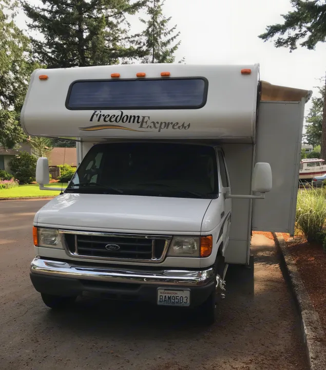 A white Freedom Express Class C RV parked on pavement, ideal for your next rv rental adventure or family trip.. Other Other 2008