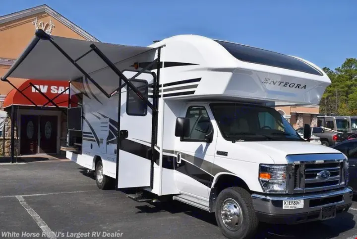 White Entegra Class C RV rental, awning out, parked at a dealer. This motorhome offers comfortable travel adventures.. Other Other 2019
