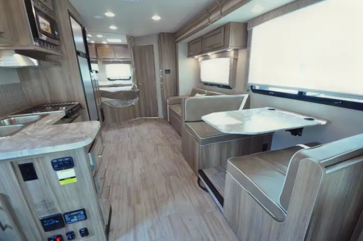 Modern RV rental interior: kitchen, dinette, and cozy sleeping area for your next road trip adventure.. Other Other 2019