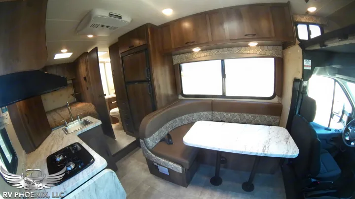 Spacious RV rental interior with modern kitchen, dining booth, and plenty of storage. Great for travel.. Coachmen Freelander 2019