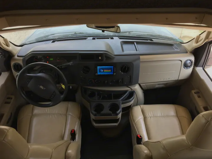 RV rental: Clean and spacious Ford E-Series cab interior, ready for your road trip adventure.. Gulf Stream Conquest 2018