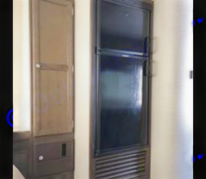 RV rental interior: black refrigerator/freezer, tall wardrobe, and lower storage cabinets.. Keystone Bullet 2018