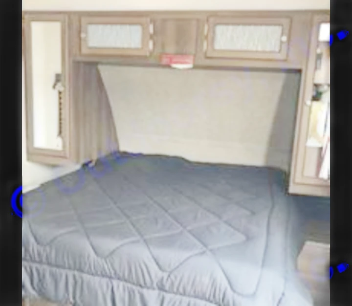 This RV rental bedroom features a comfy bed, mirrored closet, and ample overhead storage. Perfect for your next travel trailer trip.. Keystone Bullet 2018