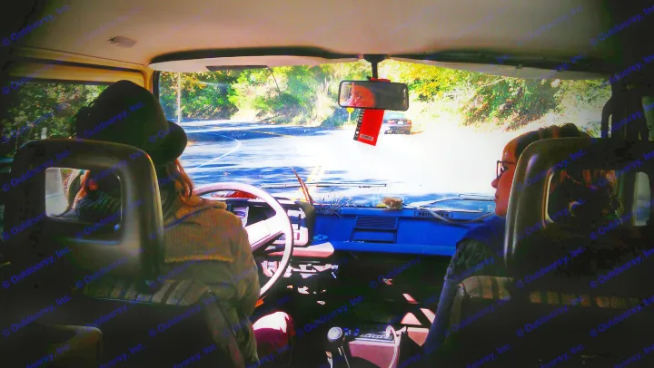 Inside an RV rental on a scenic road trip. Driver & passenger enjoy the view of the winding road ahead.. Volkswagen Vanagon 1984