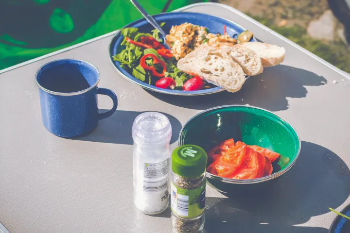 RV rental breakfast setup: enamelware mug, plate with salad, eggs, bread, tomatoes, salt & pepper. Perfect outdoor dining.. honda stepwagon 2022