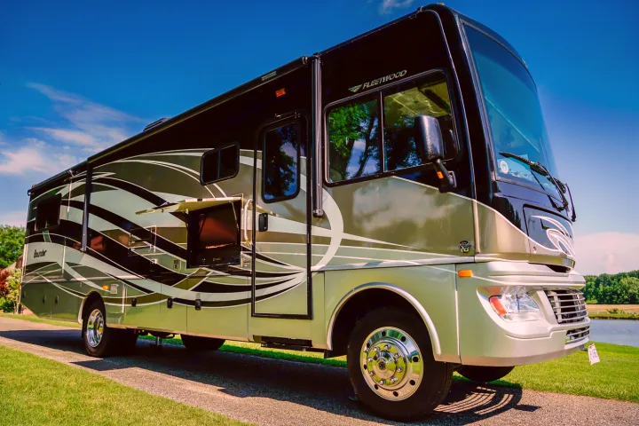 This sleek black and green Class A motorhome, featuring an open outdoor kitchen, is perfect for your next rv rental adventure.. Fleetwood Bounder 2015