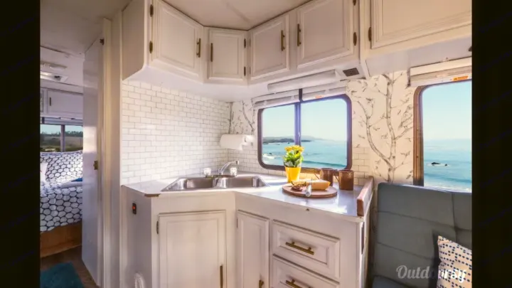 RV rental: Bright interior kitchen with white tile backsplash, ocean view window. Bedroom and seating area visible.. Other Other 1992