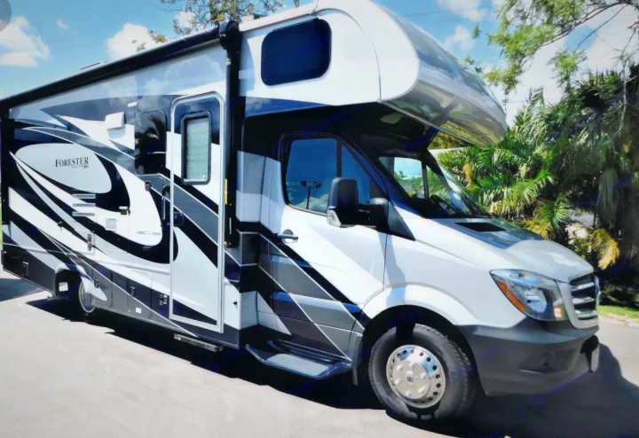White Forester RV rental parked outdoors, featuring sleek black and gray graphics.. Forest River Mercedes 2019
