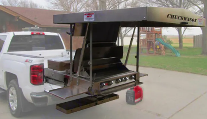 A pickup truck features a tailgate-mounted "CHUCKWAGON" mobile kitchen, with a grill and generator, great for rv rental-style outdoor meals.. Grill n Chill Vehicle Ford F150 2012
