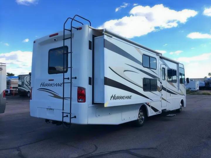 White Hurricane RV rental, a spacious motorhome with an extended slide-out and ladder, parked for your next travel adventure.. Ford Hurricane 2011