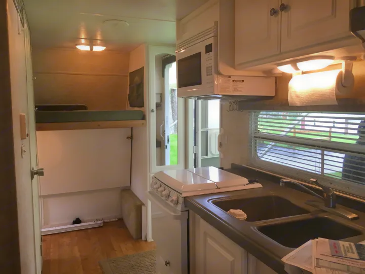 Interior view showing kitchen, bunk beds and main door. . Keystone Outback 2004