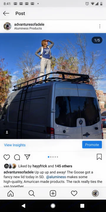 A person stands on a spacious RV rental van with its new roof rack and ladder, ready for adventure!. Mercedes-Benz Sprinter 2016