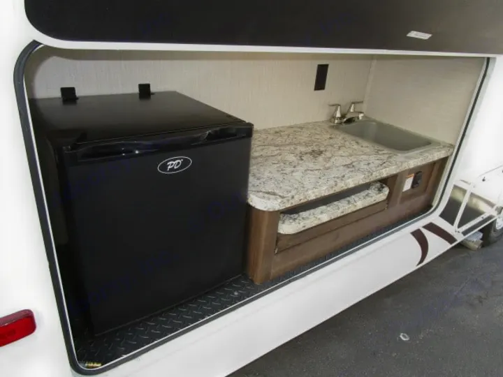 RV rental: outdoor kitchen with mini-fridge, sink, and granite counter. Enjoy convenient camping and cooking on your trip!. Jayco Redhawk 2019
