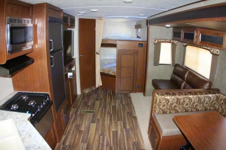 Check out the HUGE living, cooking and dining area in our trailer.  The bunk room is at the rear of the photo to the right.  The bath is through the door at the left rear of the photo.. Keystone Hideout 2017