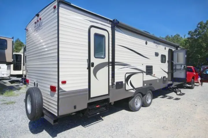 Large lighted retractable awning, outdoor kitchen with two burner stove and outdoor refrigerator makes an excellent outdoor entertaining space.  Separate rear entrance for accessing the interior of the trailer without having to put out slides or for stepping into the restroom without tracking through the living area.. Keystone Hideout 2017
