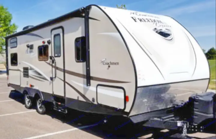 Light-colored RV rental parked on asphalt. Perfect for your next outdoor adventure!. Coachman Freedom 2017