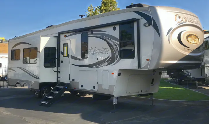 This large white & gray Columbus Compass Series fifth-wheel RV is ready for your next rv rental adventure or camping trip.. Palomino Columbus 2018
