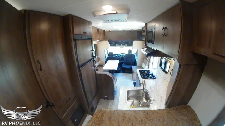 Explore this RV rental interior: a full kitchen, dinette, and front cab with overhead bunk are visible. A compact, functional living space.. Coachmen Freelander 2019