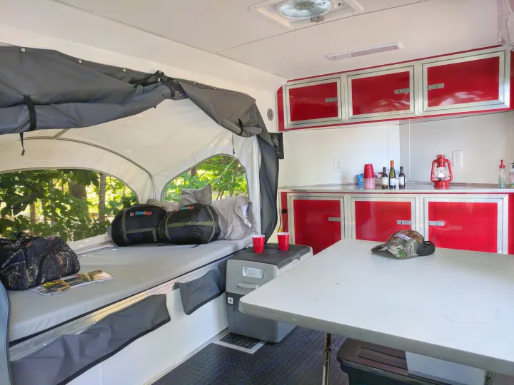 Spacious RV rental interior with sleeping area, kitchen, and ample storage, perfect for outdoor adventures.. United XLMTV-610 2018
