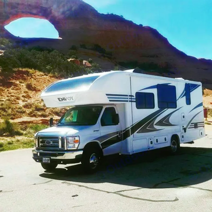 This white rv rental is parked before a stunning natural rock arch. Perfect for your next scenic desert adventure!. Jayco Envoy 2018
