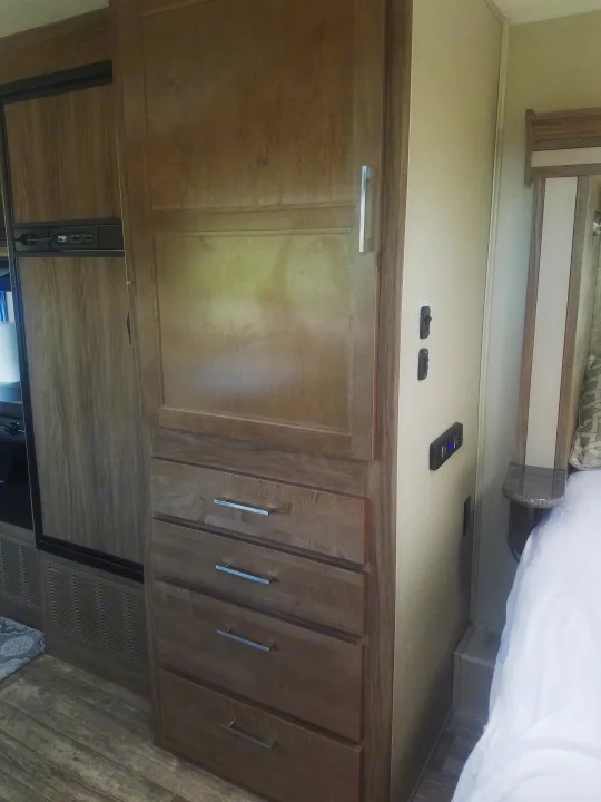 RV rental: Interior view with built-in wood cabinets, drawers, a refrigerator, and part of the bedroom area.. Jayco Envoy 2018