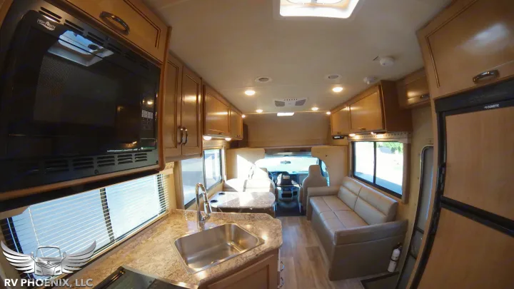 Spacious RV rental motorhome interior: full kitchen with microwave, sink; sofa lounge, dining, and cockpit up front.. Thor Motor Coach Four Winds 2019