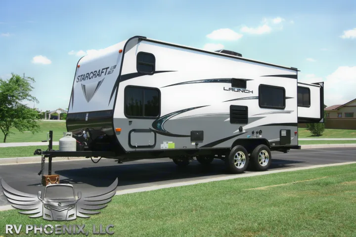 Starcraft Launch travel trailer, perfect for your next RV rental. White RV with gray accents parked outdoors on a sunny day.. Starcraft Launch 19BHS 2017