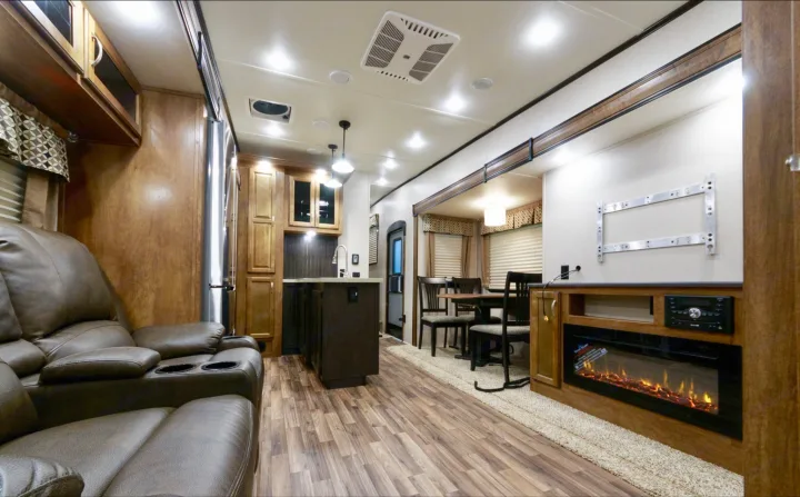 Indoor Living Space with fireplace, theater seating, kitchen peninsula and dining table!  Reclining seats with heat and massage!  TV has been added since the picture was taken.. Coachmen Chaparral 373MBRB 2019