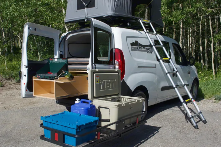 RV rental adventure awaits! White camper van with rooftop tent, outdoor kitchen, and YETI gear for your next trip.. Ram Promaster City 2018