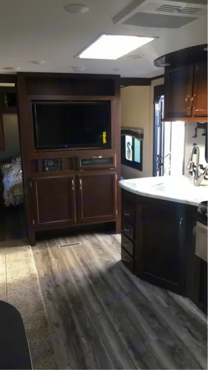Spacious RV rental interior with modern kitchen, entertainment area, and bedroom glimpse, ideal for travel.. Jayco Flight 2018