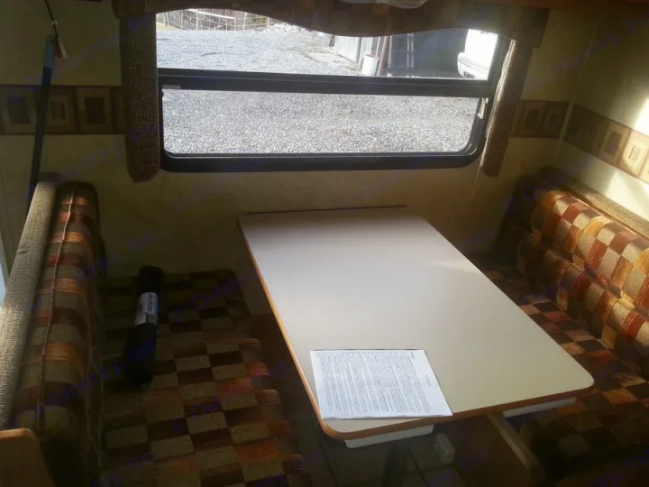 **RV rental dinette setup:** Interior with a table, two patterned bench seats, and a large window view to the outside.. R-Vision TS 24BH 2011