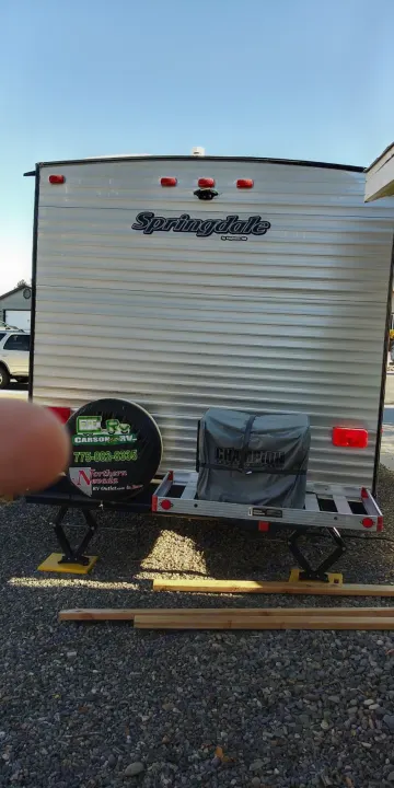 Rear view of an RV rental: a Springdale travel trailer with a spare tire and generator on a carrier. Great for camping trips!. Keystone RV Springdale 2018